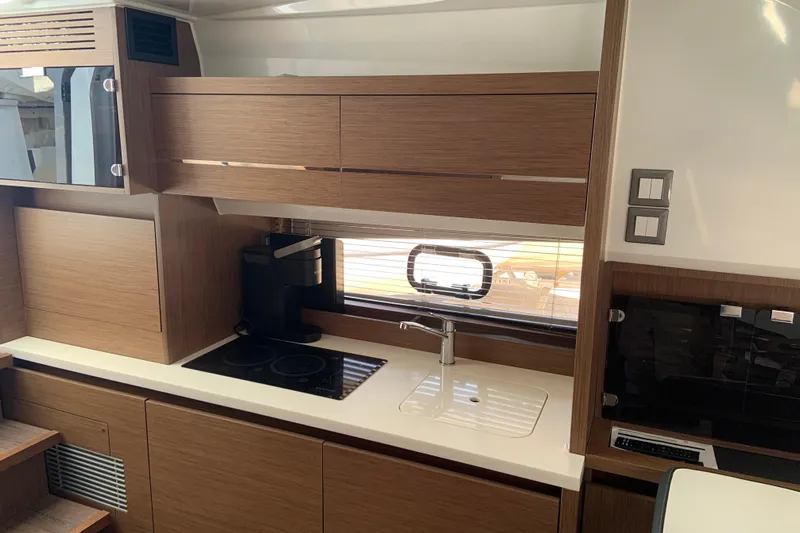  Yacht Photos Pics Modern kitchen area in 2021 Jeanneau Leader 12.5 WA yacht with stove and sink.