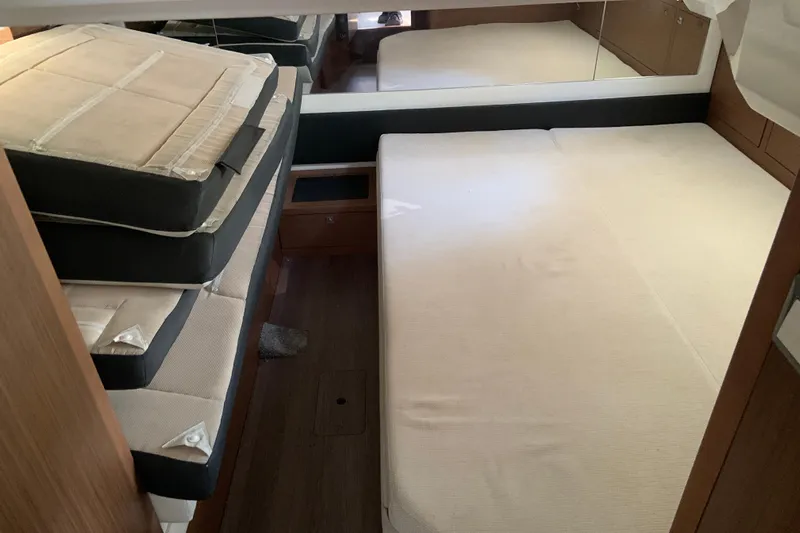  Yacht Photos Pics Interior cabin of 2021 Jeanneau Leader 12.5 WA with stacked cushions.