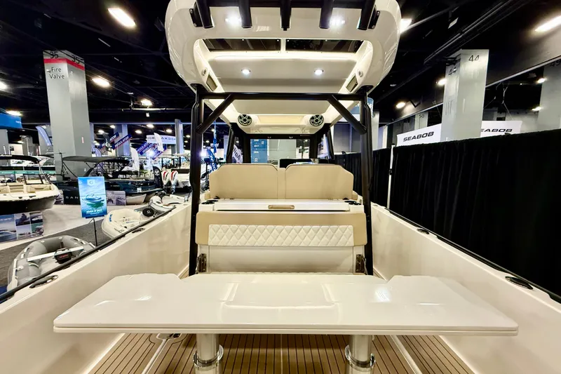  Yacht Photos Pics 2026 Zodiac X9CC boat interior at a showroom, featuring seating and modern design elements.