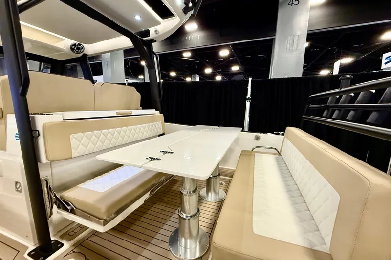  Yacht Photos Pics Luxurious interior of 2026 Zodiac X9CC boat with elegant seating and table.