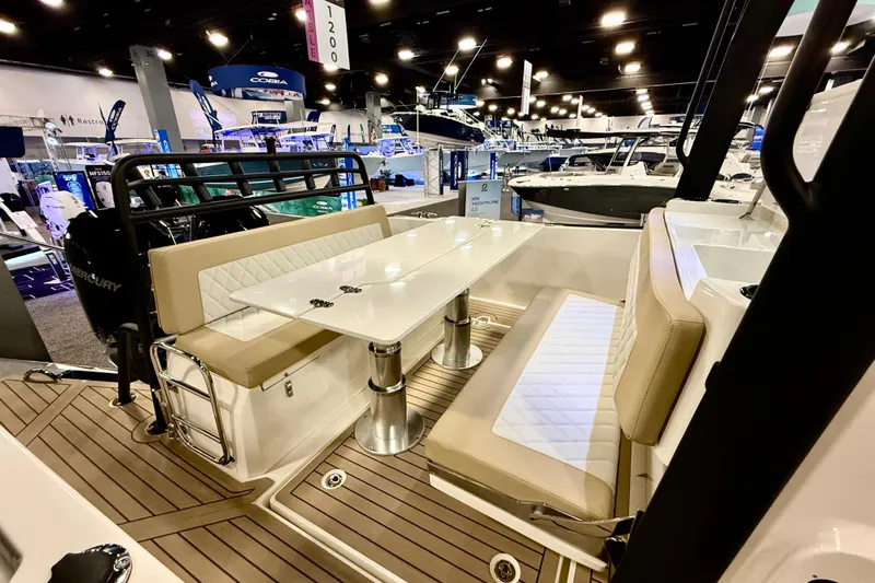  Yacht Photos Pics Zodiac X9CC 2026 boat interior with seating and table at a boat show.