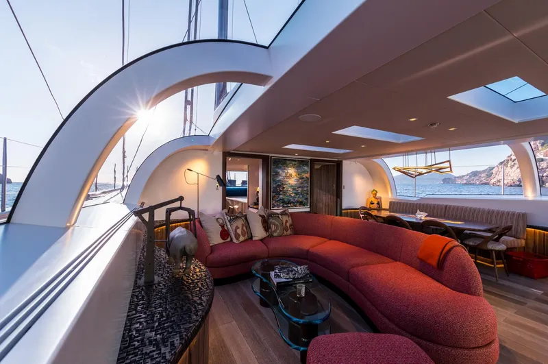 Ngoni Yacht Photos Pics Luxurious interior of 2017 Royal Huisman Dubois Mega Sloop with red sofa.