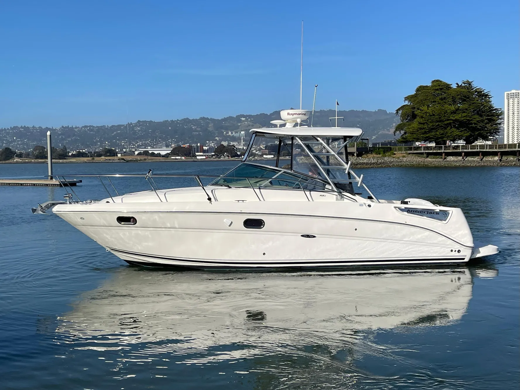 2005 Sea Ray Amberjack 290 boat on calm water, clear sky background.