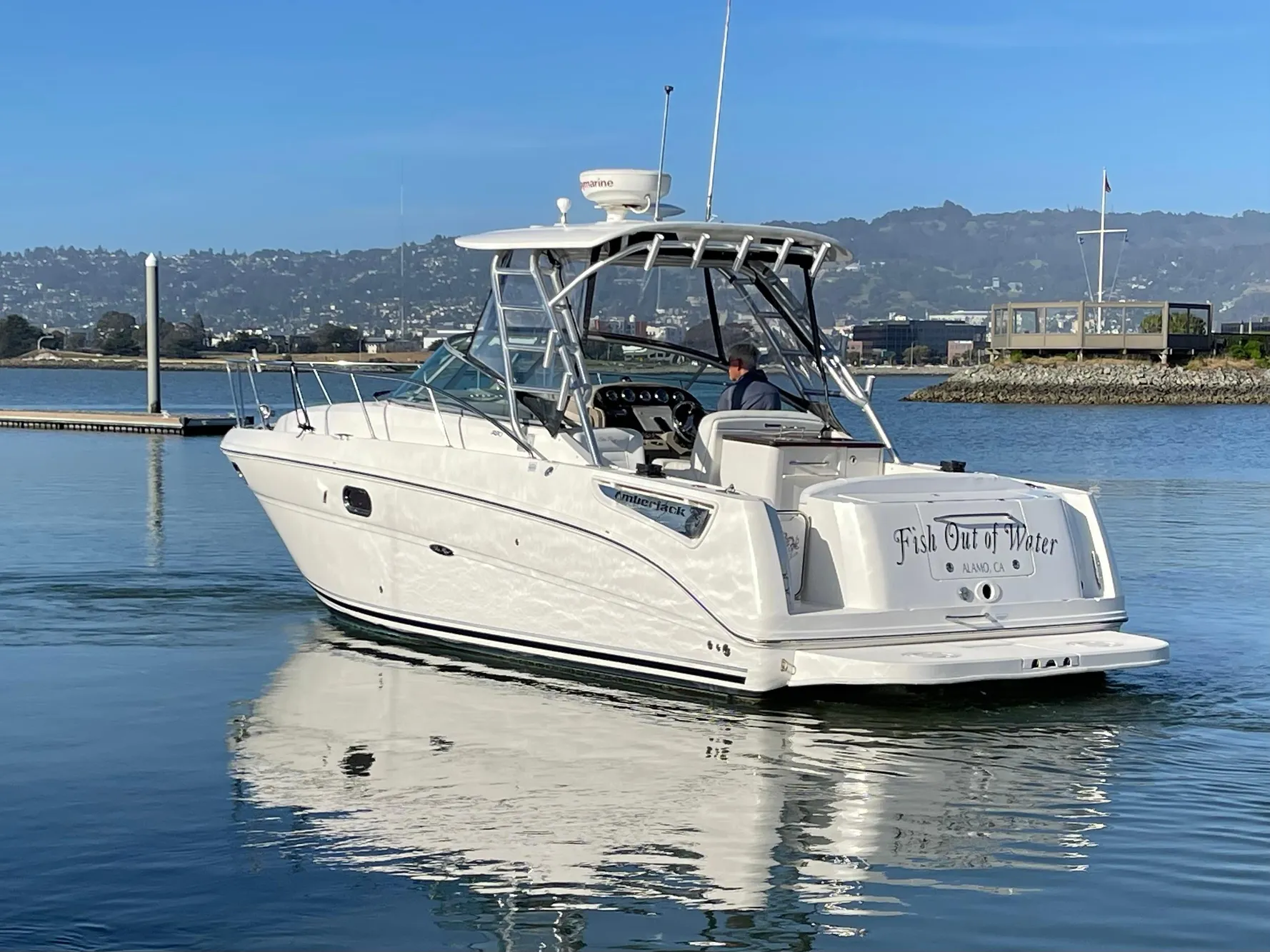 2005 Sea Ray Amberjack 290 boat on calm water, with scenic background.