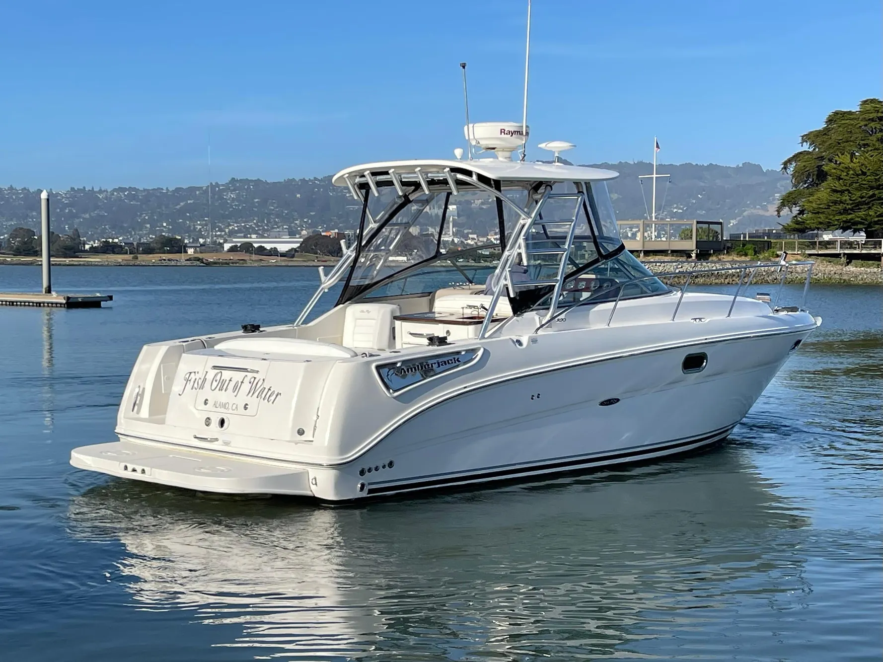 2005 Sea Ray Amberjack 290 boat on calm water, clear sky background.