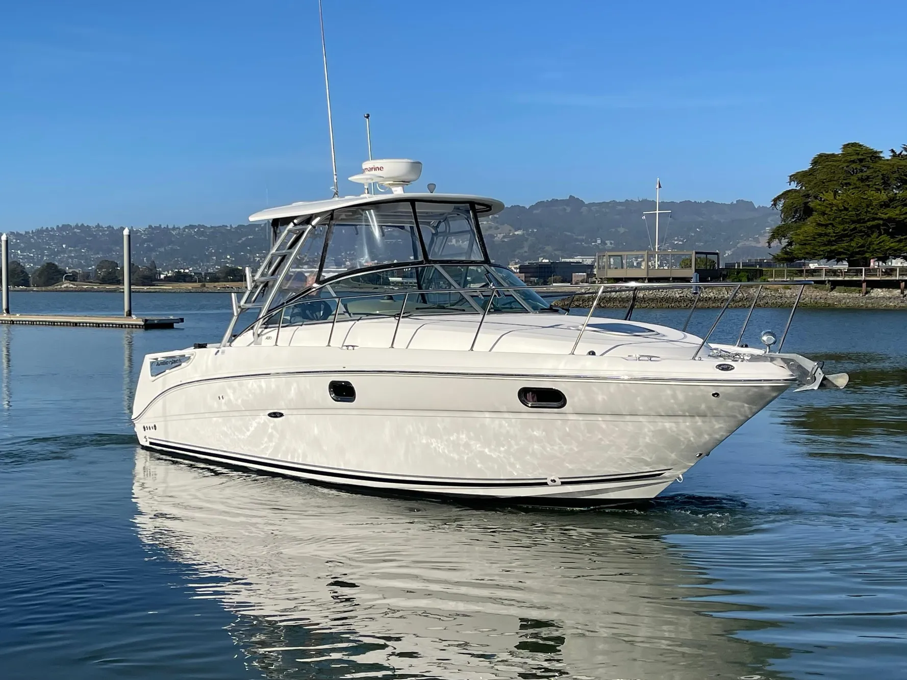 2005 Sea Ray Amberjack 290 boat on calm water, clear sky background.