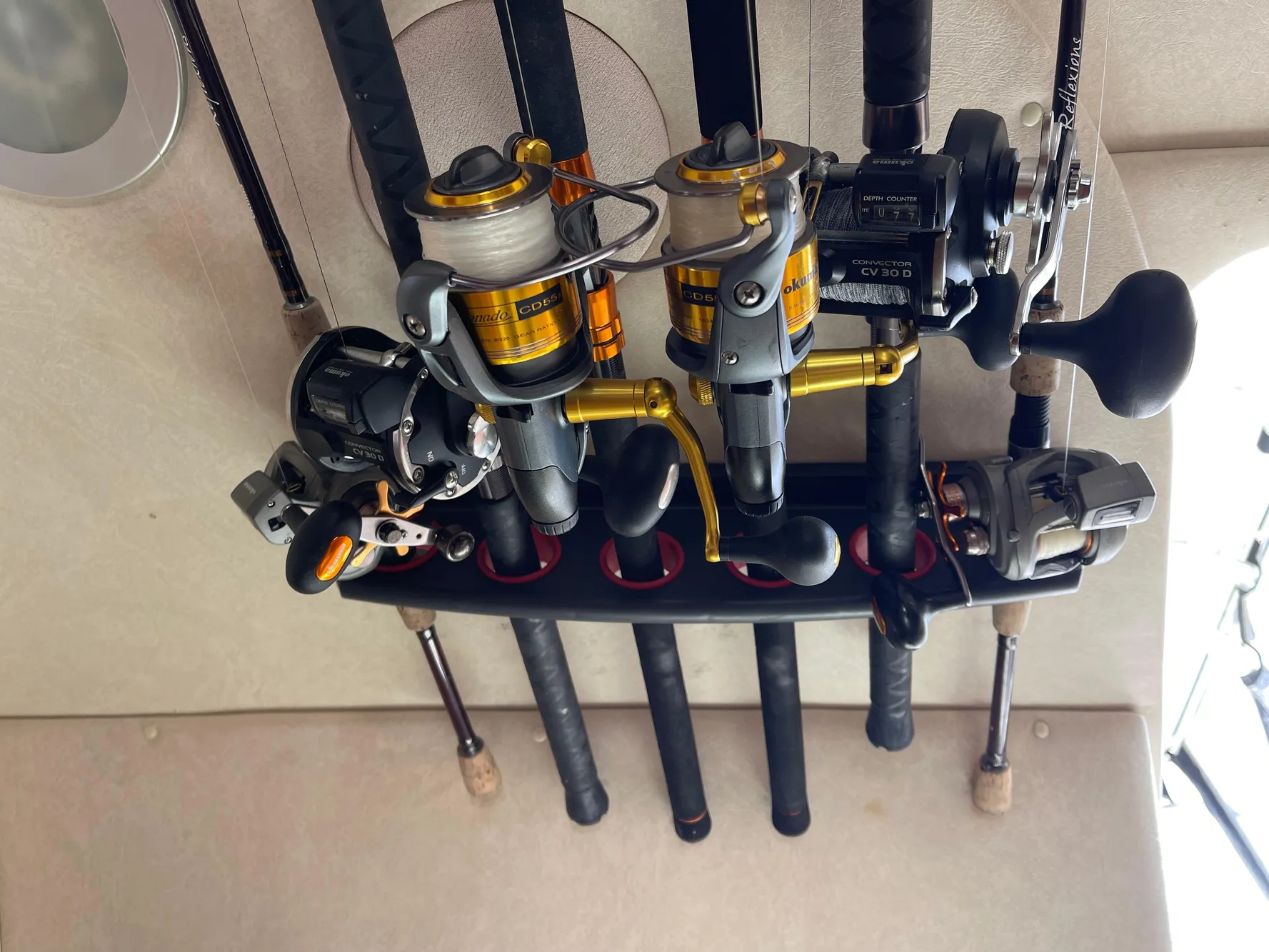 Fishing rods and reels stored on a 2005 Sea Ray Amberjack 290 boat.