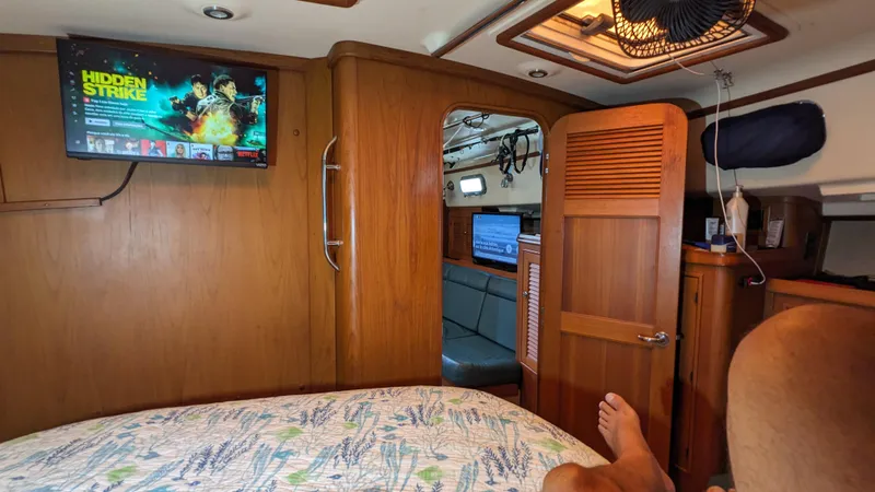 Mawe Yacht Photos Pics Cozy interior of 2006 Island Packet 440 yacht with TV and wooden furnishings.