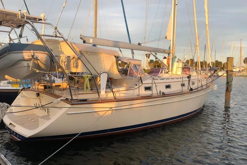 Mawe Yacht Photos Pics 2006 Island Packet 440 sailboat docked at marina during sunset.