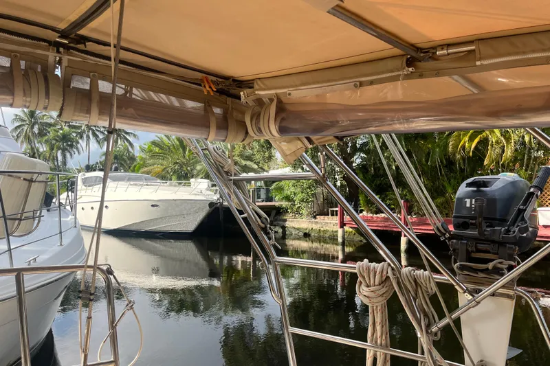 Mawe Yacht Photos Pics Sailboat view from Island Packet 440, 2006, docked near palm trees and other boats.