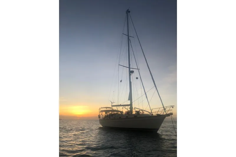 Mawe Yacht Photos Pics Sailing yacht Island Packet 440, 2006 model, at sunset on calm waters.