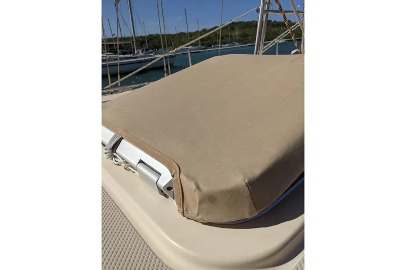 Mawe Yacht Photos Pics Tan cover on 2006 Island Packet 440 sailboat deck, with marina background.