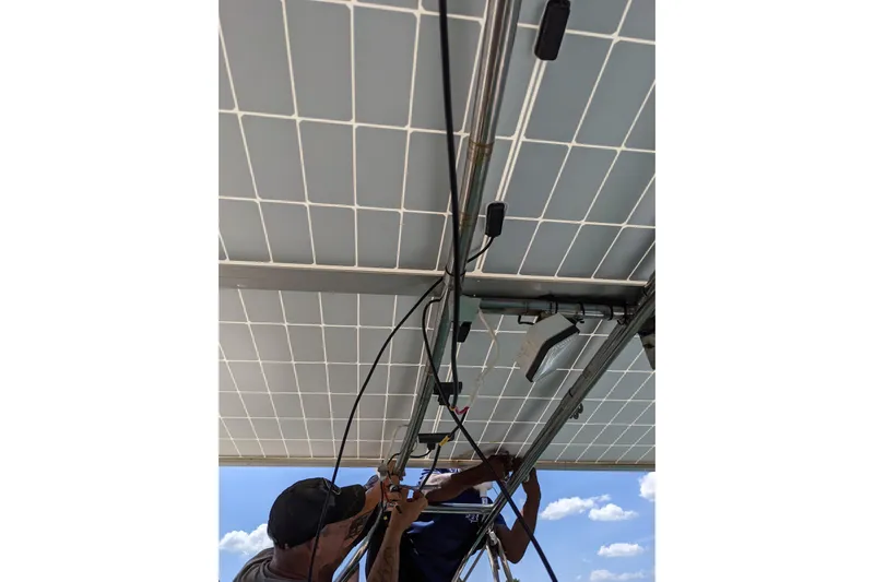 Mawe Yacht Photos Pics Technicians installing solar panels on Island Packet 440 yacht, 2006 model.