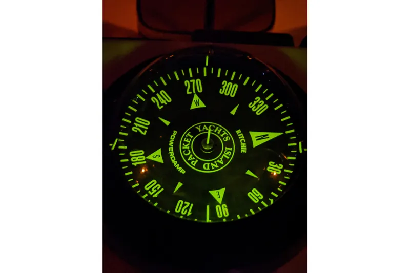 Mawe Yacht Photos Pics Glowing compass on 2006 Island Packet 440 yacht, displaying cardinal directions.