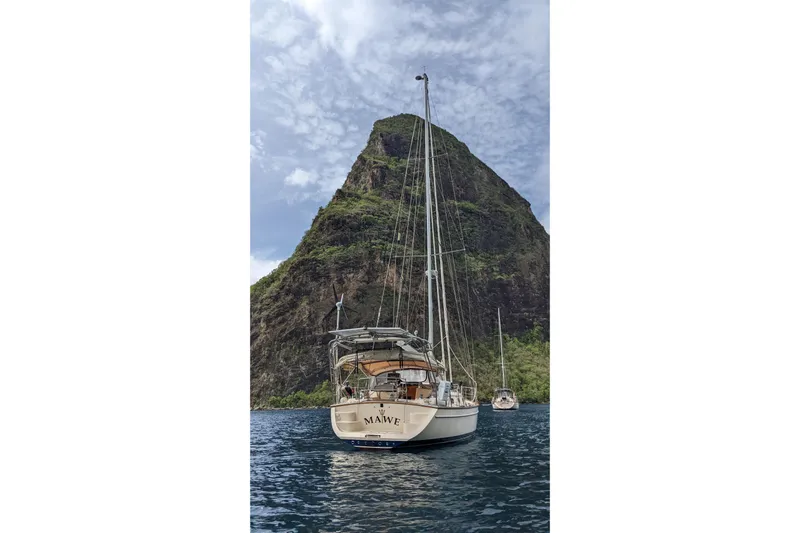 Mawe Yacht Photos Pics Sailboat Island Packet 440 (2006) anchored near a lush, mountainous island.