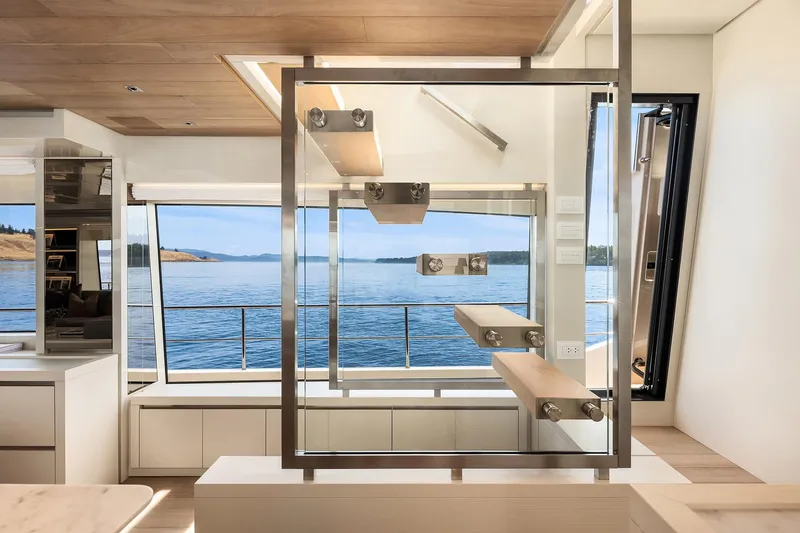Essenza Yacht Photos Pics Modern interior of 2023 Sanlorenzo SL86 yacht with sleek staircase and ocean view.