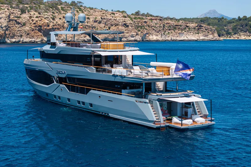 37xp-17 Yacht Photos Pics Luxurious 2026 Numarine 37XP-17 yacht cruising in clear blue waters near rocky coastline.