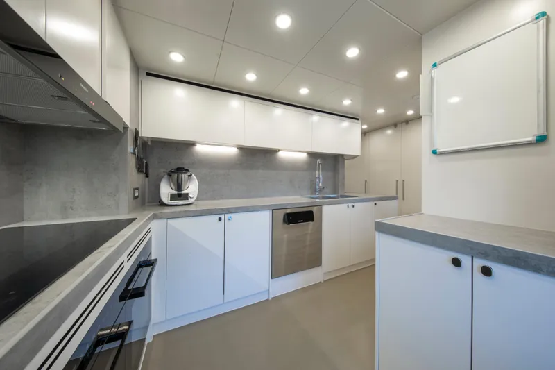 37xp-17 Yacht Photos Pics Modern kitchen interior on 2026 Numarine 37XP-17 yacht, featuring sleek white cabinetry.