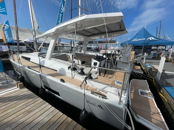 Uncorked Yacht Photos Pics 2023 Hanse 460 yacht docked at marina under clear blue sky.