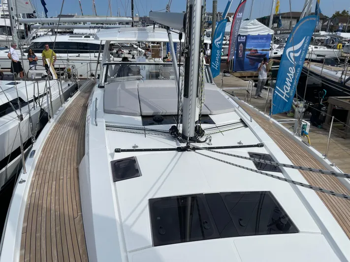 Uncorked Yacht Photos Pics 2023 Hanse 460 yacht displayed at a boat show, featuring sleek design and modern amenities.