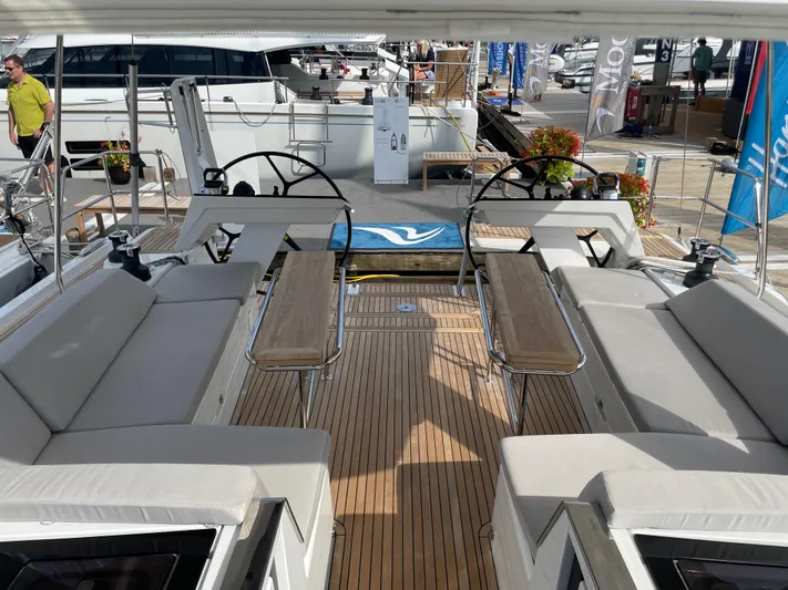 Uncorked Yacht Photos Pics 2023 Hanse 460 yacht deck with dual steering wheels and seating area.