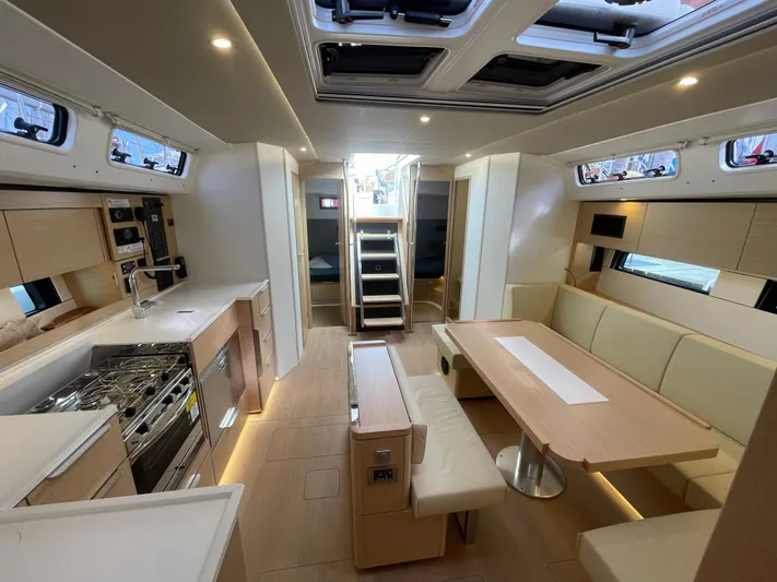 Uncorked Yacht Photos Pics Luxurious interior of 2023 Hanse 460 yacht with modern kitchen and dining area.