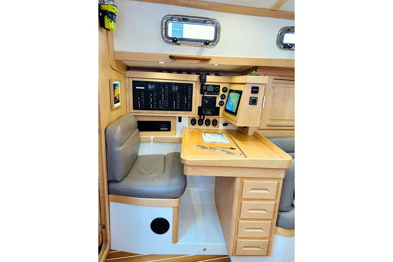 Stargazer Yacht Photos Pics Navigation station in 2019 Tartan 395 yacht with control panels and seating.