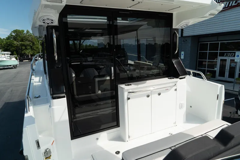 38 Explorer Yacht Photos Pics 2025 Wellcraft 355 boat with sleek design and modern amenities, docked outdoors.