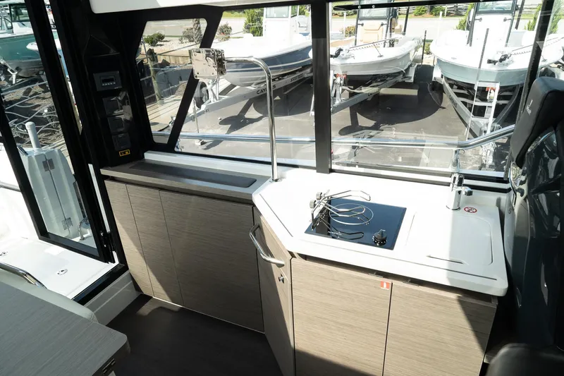 38 Explorer Yacht Photos Pics Interior of 2025 Wellcraft 355 boat with modern kitchen and large windows.