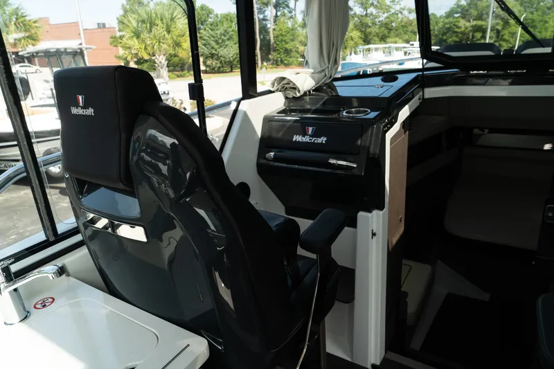 38 Explorer Yacht Photos Pics Interior of 2025 Wellcraft 355 boat, featuring helm and seating area.