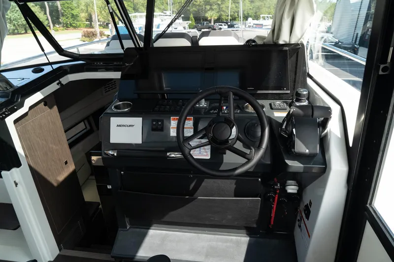 38 Explorer Yacht Photos Pics 2025 Wellcraft 355 boat cockpit with modern steering and navigation controls.