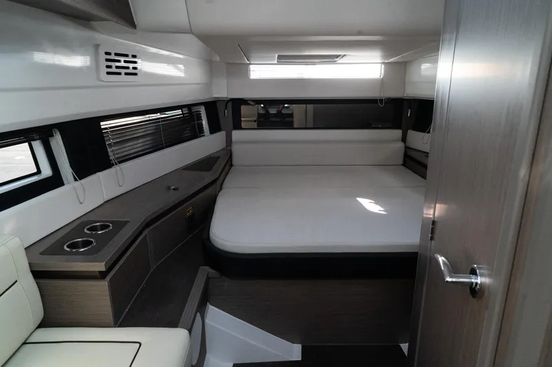 38 Explorer Yacht Photos Pics Interior cabin of 2025 Wellcraft 355 boat, featuring a cozy bed and modern design.