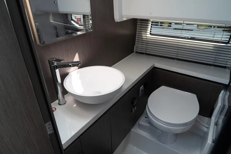 38 Explorer Yacht Photos Pics Modern bathroom in 2025 Wellcraft 355 boat with sleek sink and toilet.