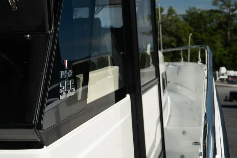 38 Explorer Yacht Photos Pics 2025 Wellcraft 355 boat, sleek design, side view with railing and window details.