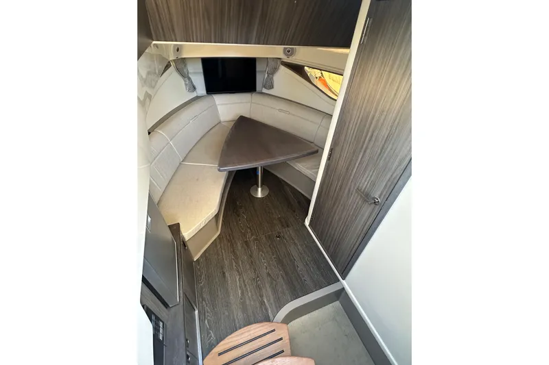  Yacht Photos Pics 2020 Sea Ray Sundancer 320 Outboard cabin interior with seating and table.