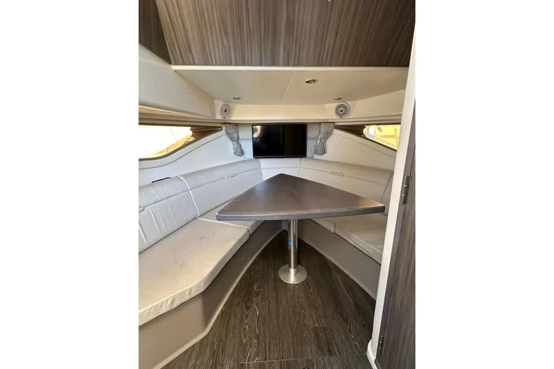  Yacht Photos Pics 2020 Sea Ray Sundancer 320 Outboard cabin interior with seating and table.