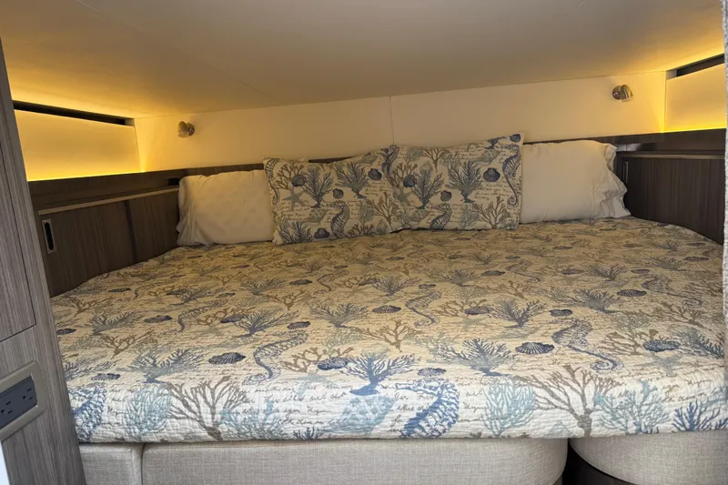  Yacht Photos Pics Cozy cabin bed in 2020 Sea Ray Sundancer 320 Outboard with nautical-themed bedding.