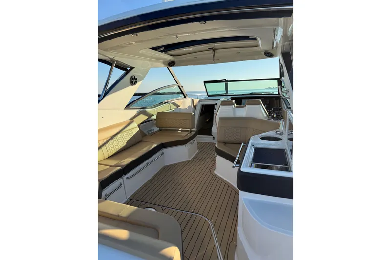  Yacht Photos Pics 2020 Sea Ray Sundancer 320 Outboard interior with seating and helm, featuring modern design.