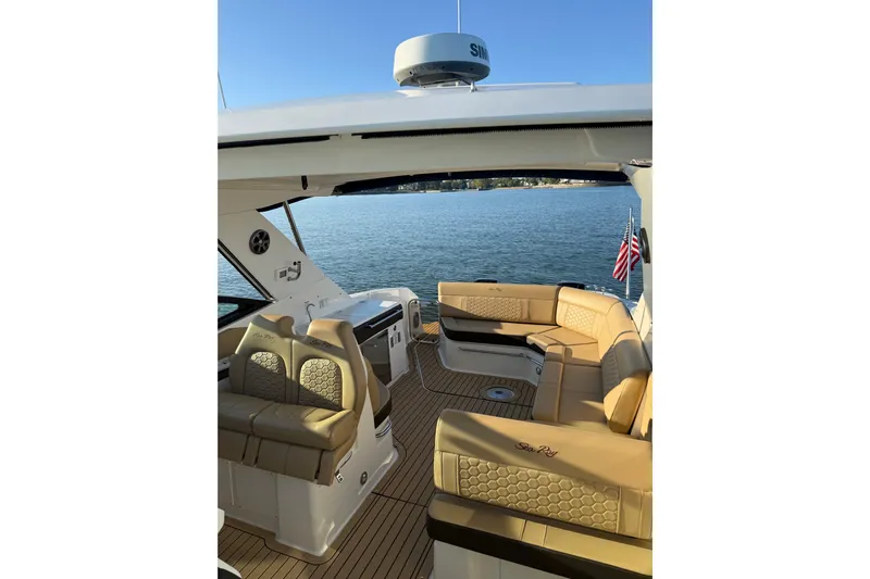  Yacht Photos Pics 2020 Sea Ray Sundancer 320 Outboard interior with tan seating, overlooking serene water.