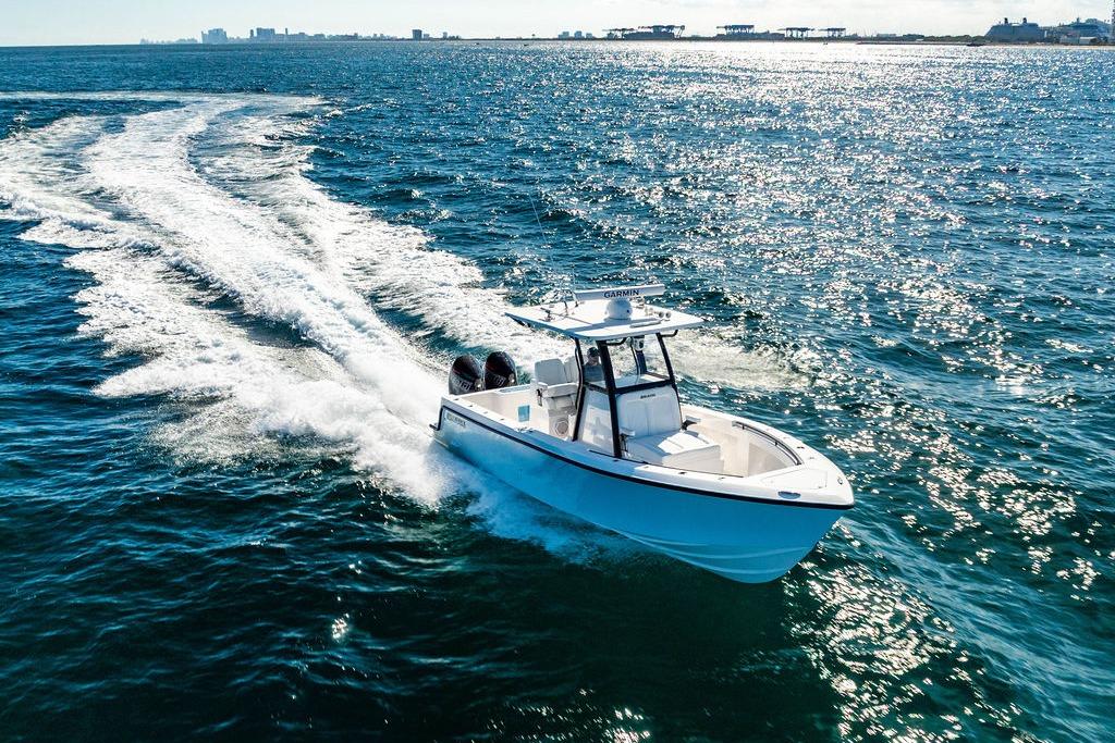 2026 Reef Runner 280 boat cruising on open water under clear skies.
