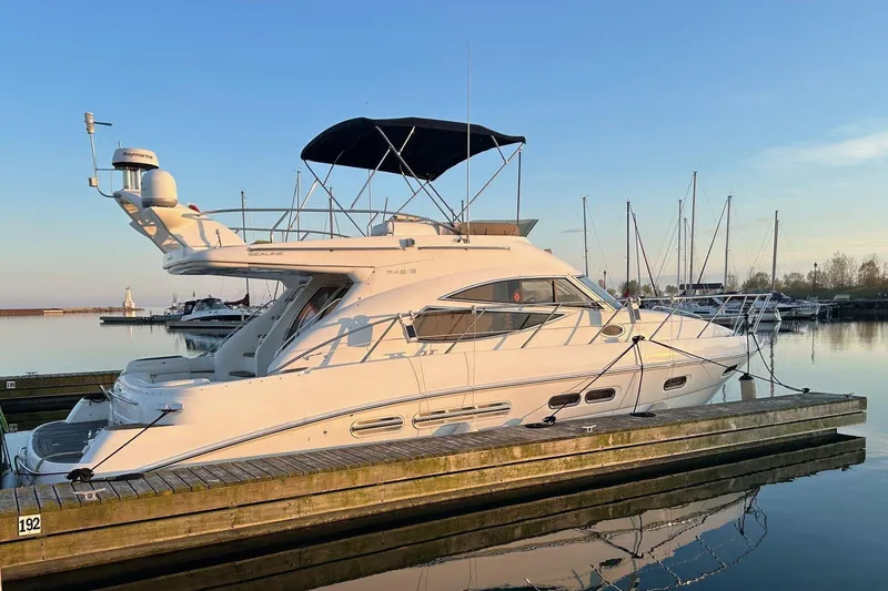 Pilot House Yacht Photos Pics 2003 Sealine F42/5 yacht docked at marina during sunset.