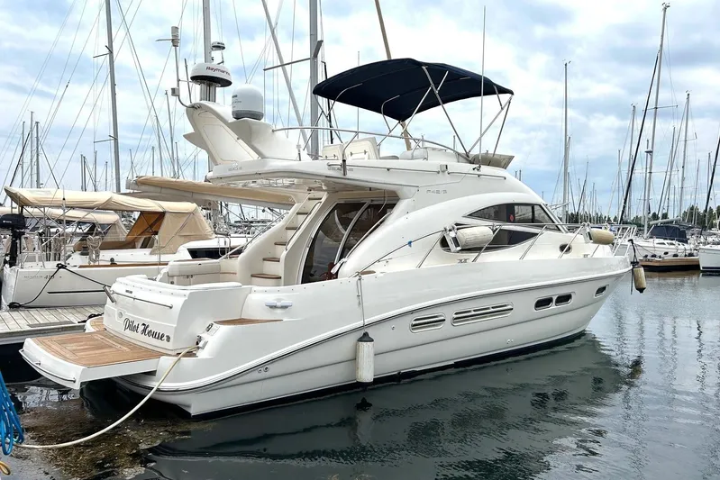 Pilot House Yacht Photos Pics 2003 Sealine F42/5 yacht docked at marina, featuring sleek design and spacious deck.