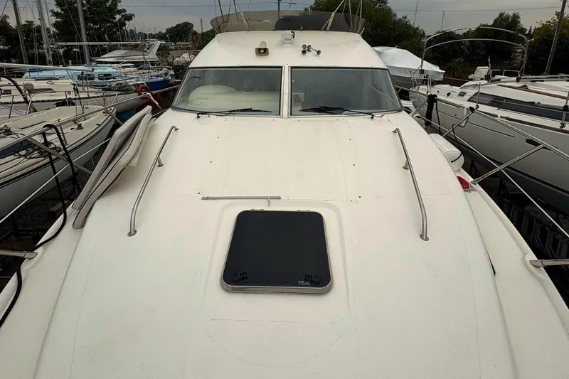 Pilot House Yacht Photos Pics 2003 Sealine F42/5 yacht docked among other boats, showcasing its sleek design.