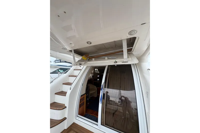 Pilot House Yacht Photos Pics 2003 Sealine F42/5 yacht interior with stairs and sliding glass door.