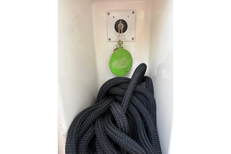 Pilot House Yacht Photos Pics Key ignition and coiled black rope in a 2003 Sealine F42/5 boat compartment.