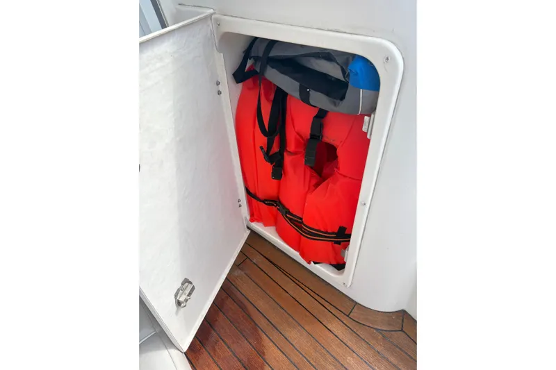 Pilot House Yacht Photos Pics Storage compartment with life jackets on a 2003 Sealine F42/5 boat.