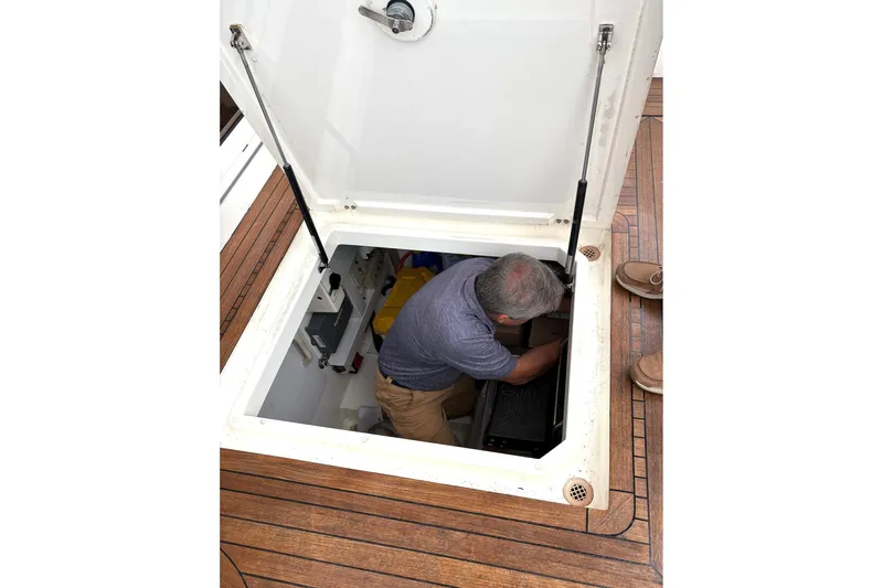 Pilot House Yacht Photos Pics Man working in engine compartment of 2003 Sealine F42/5 yacht.