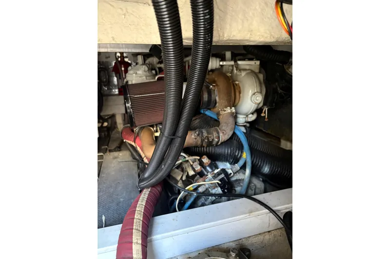 Pilot House Yacht Photos Pics Engine compartment of a 2003 Sealine F42/5 boat, showcasing hoses and mechanical components.