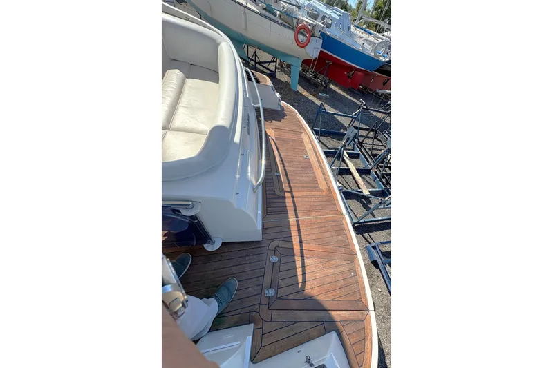 Pilot House Yacht Photos Pics 2003 Sealine F42/5 yacht deck with wooden flooring and seating area.