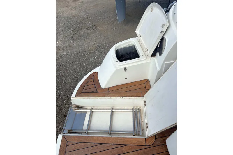 Pilot House Yacht Photos Pics 2003 Sealine F42/5 yacht deck with open storage compartment and ladder.